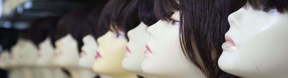 Different styles of wigs worn by different mannequins.