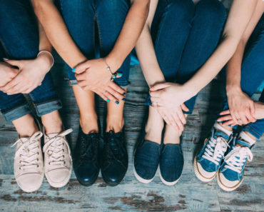 A group of friends with different types and styles of sneakers.