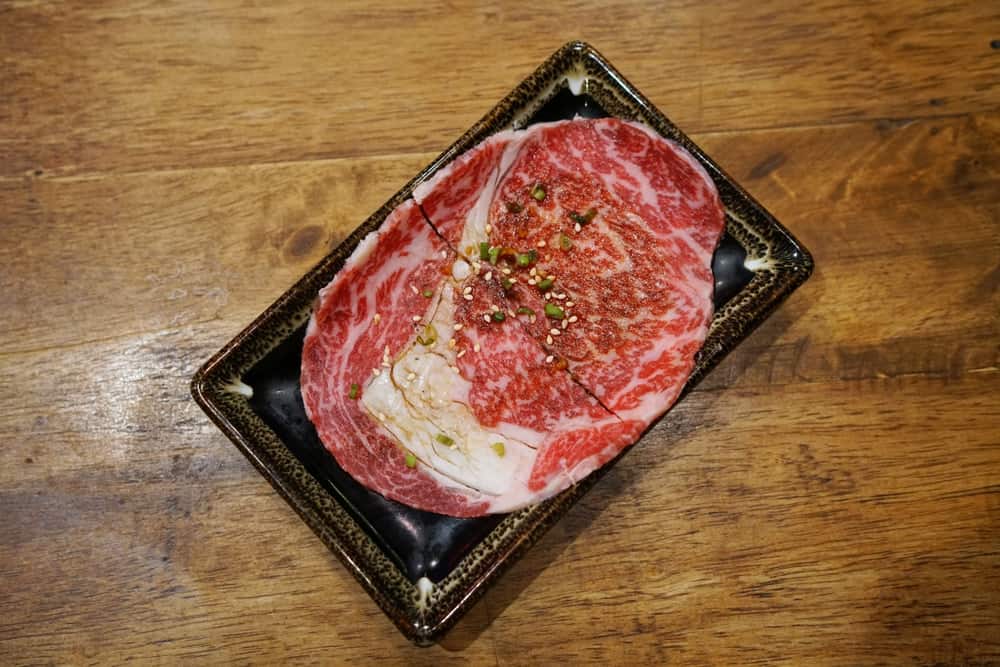 Premium raw thin sliced wagyu ribseye prepared for Japanese style barbecue