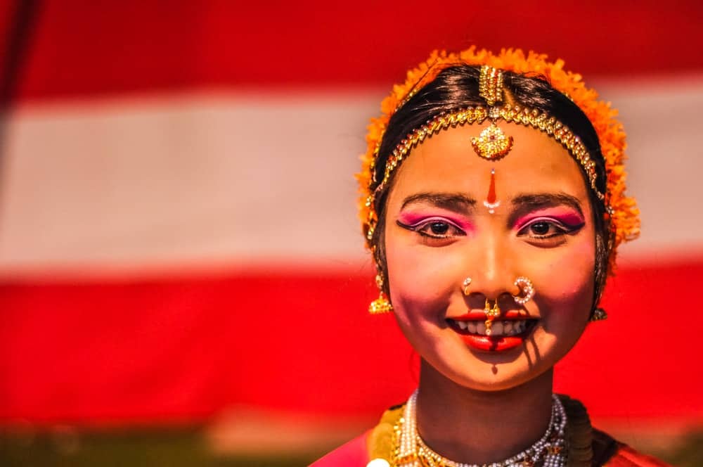 Beautiful young woman with piercings in her nose and pink eyeshadows during performance at Bihu festival in Guwahati, Assam.