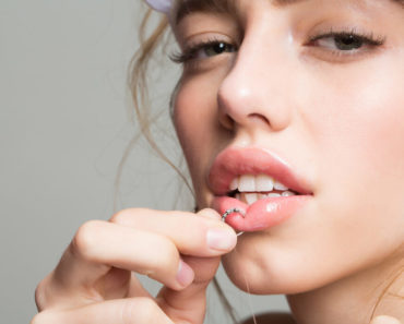 A model showing-off her lip piercing.