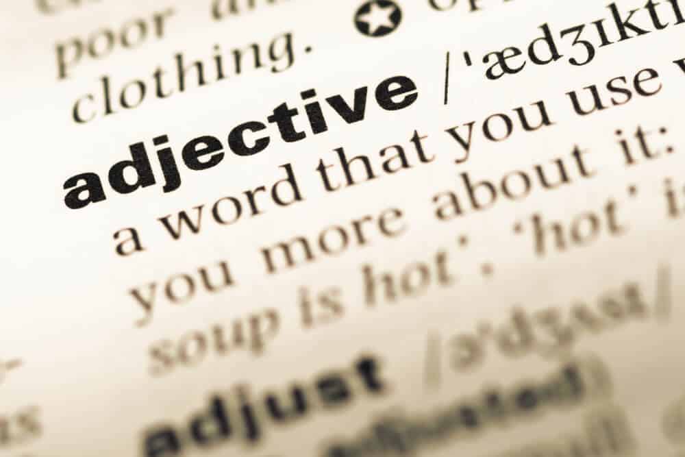 A close-up shot from the dictionary of the word adjective.
