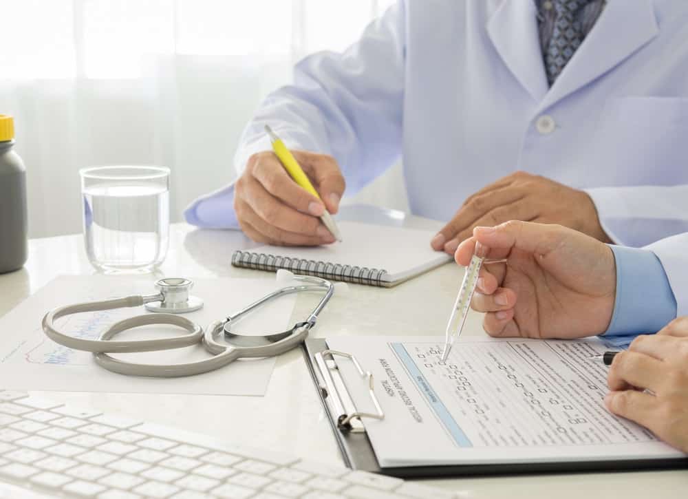 A doctor is preparing his clinical case study article with his colleague.