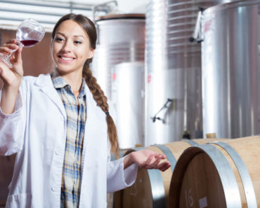 A woman keenly observing the product of their fermentation.