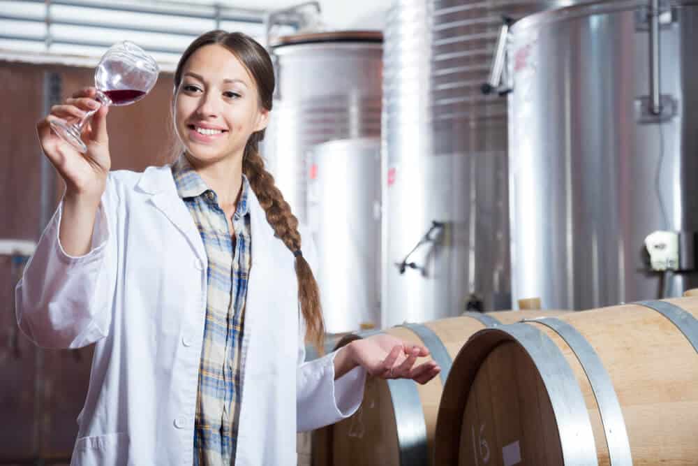 A woman keenly observing the product of their fermentation.
