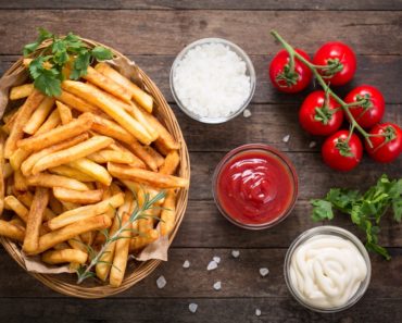 French fries served with condiments on the side.