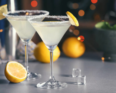 Lemon martini cocktails with sliced lemons.