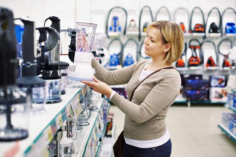 A lady is shopping for personal household items.