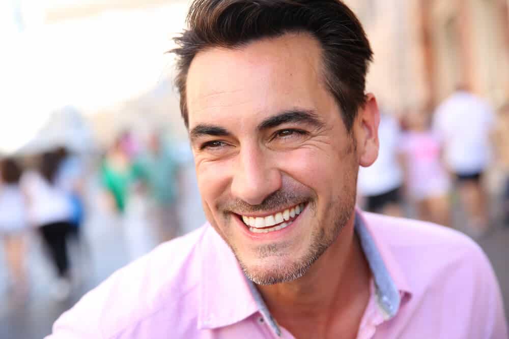 A man smiling. exposing his healthy teeth.