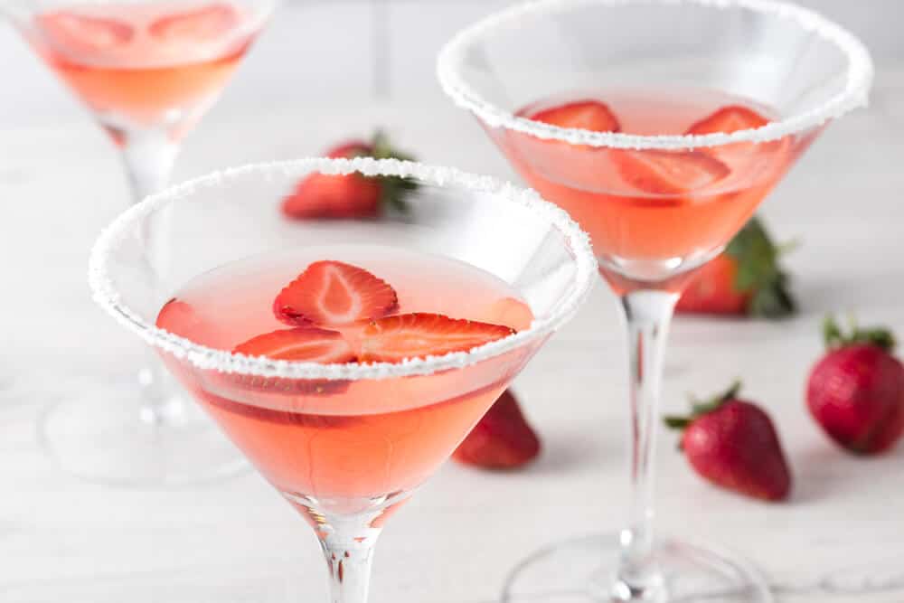Three servings of homemade strawberry martinis.