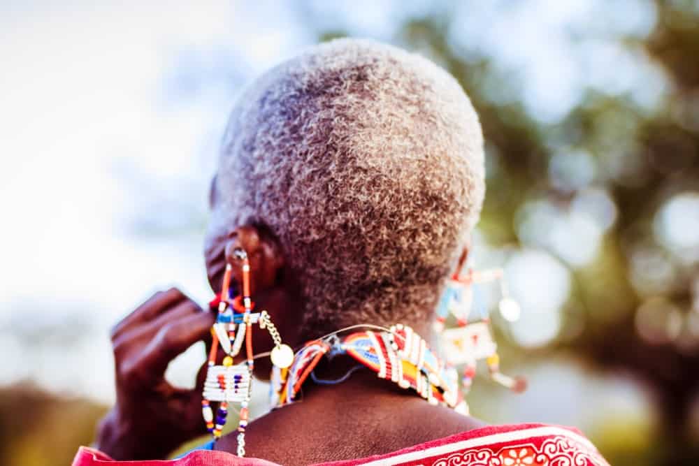 Back view of an ethnic woman with colorful large earrings.