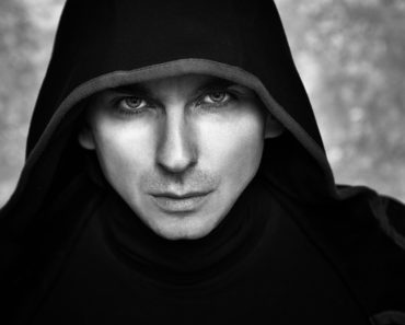 A male mage who is cloaked in black.