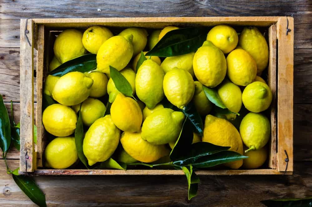 Organic lemons on a wooden crate.