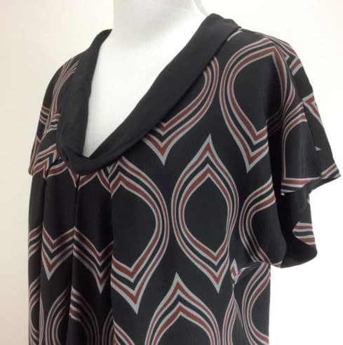 Black blouse with rolled collar.