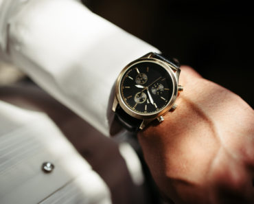 Elegant analog dress watch on fomrally dressed man