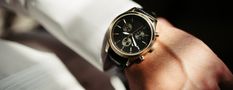 Elegant analog dress watch on fomrally dressed man