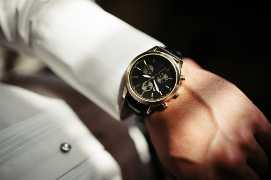 Elegant analog dress watch on fomrally dressed man
