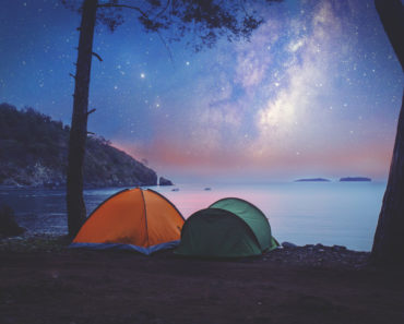 Tent camping on shore at night