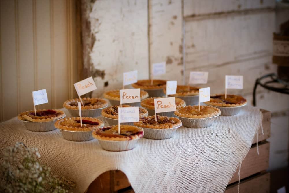 Pies on a decorated table during a wedding ceremony.