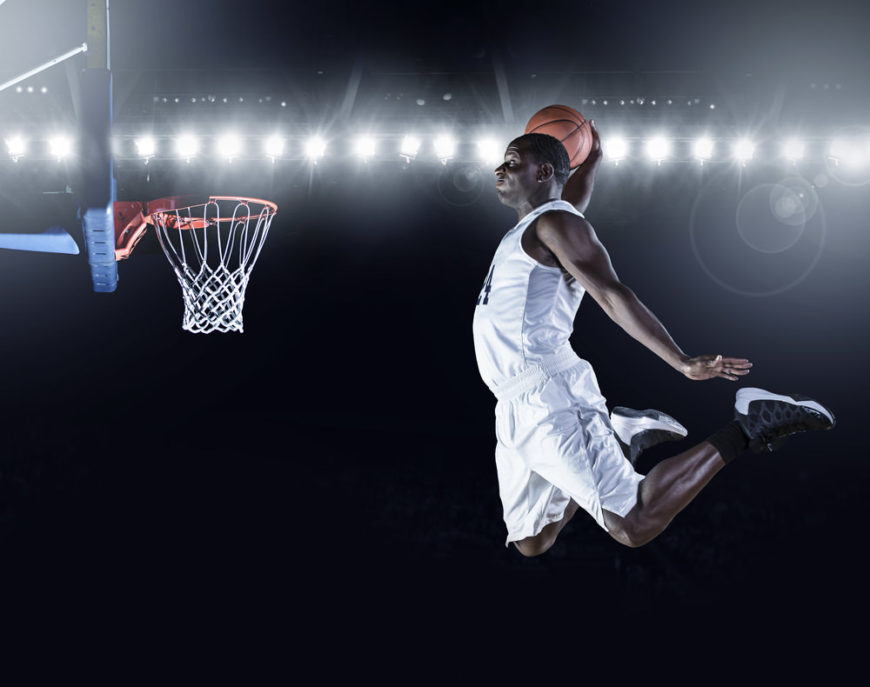 Basketball player slam dunking