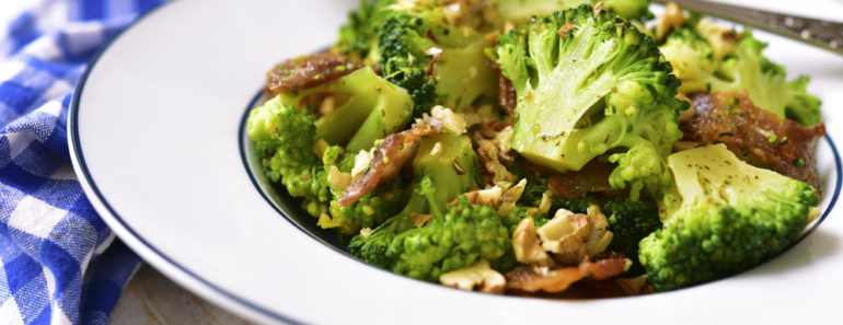 Bowl of cooked broccoli with walnuts