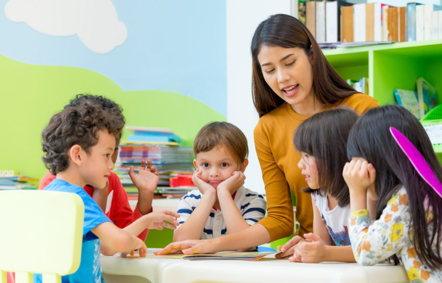 Daycare provider teaching young daycare students