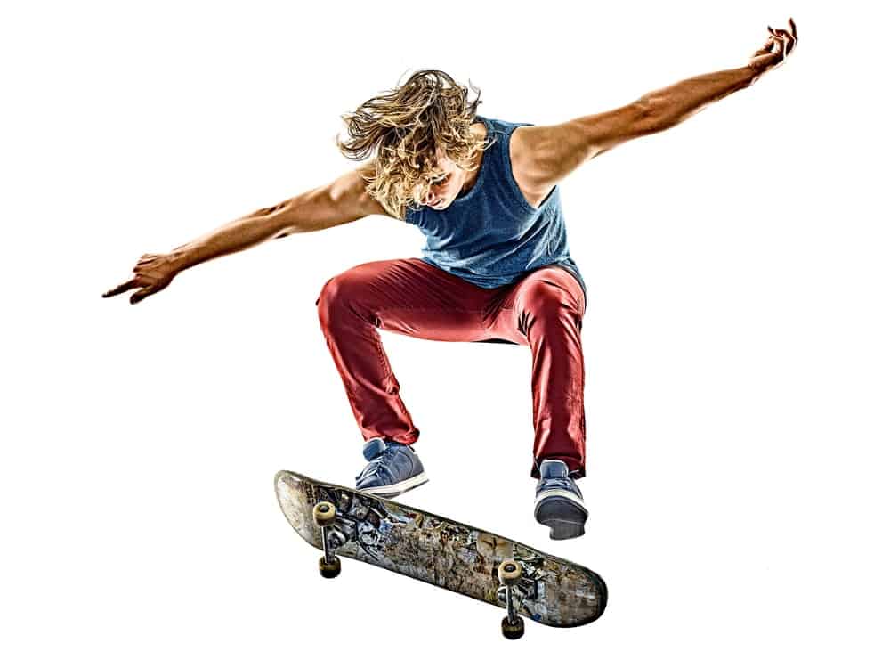 A young man on an exhibition while skateboarding.