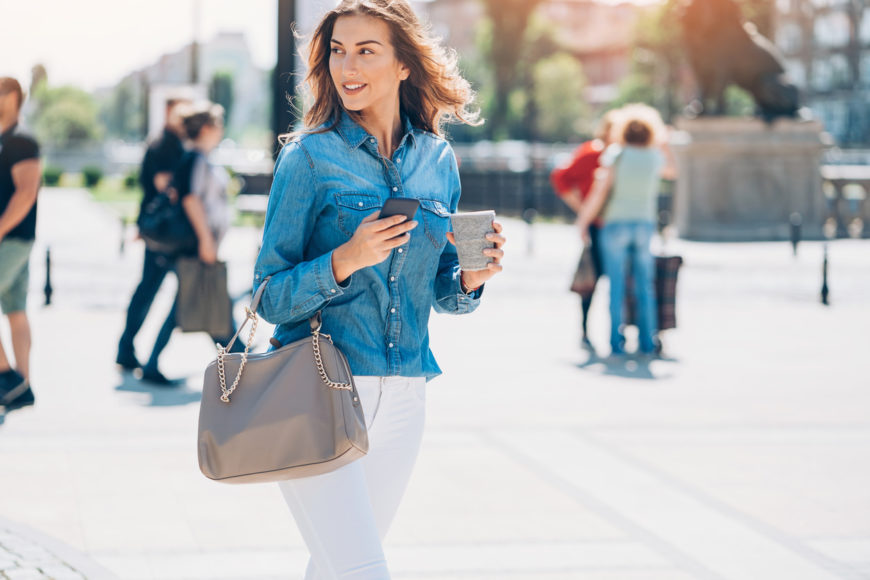 Woman carrying handbag on the street.