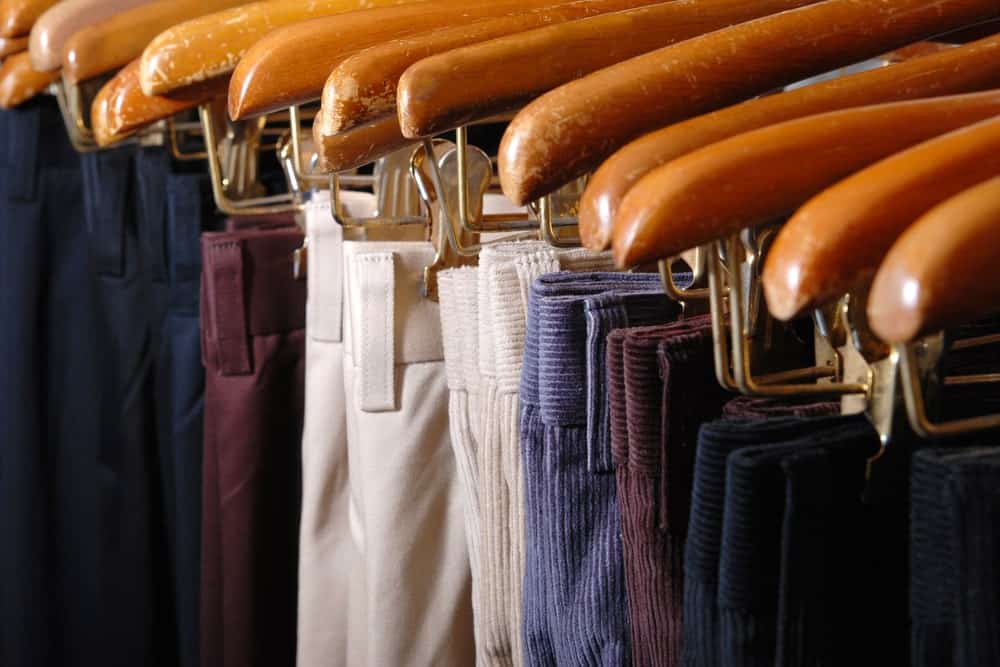 Pants and trousers hanging in hangers