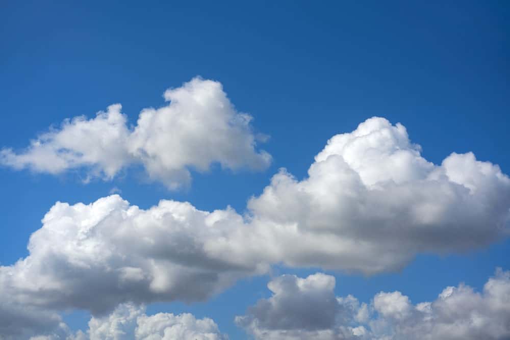 White cumulus clouds over the blue sky