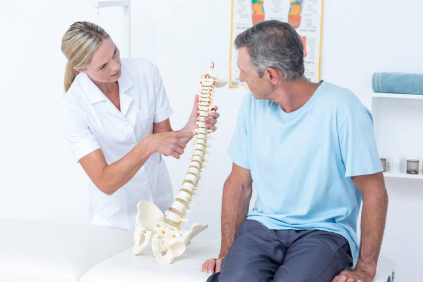 Chiropractor explaining the spine to patient