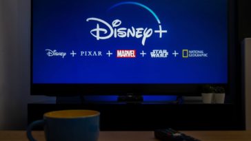 A TV showing the Disney+ logo along with its various content.