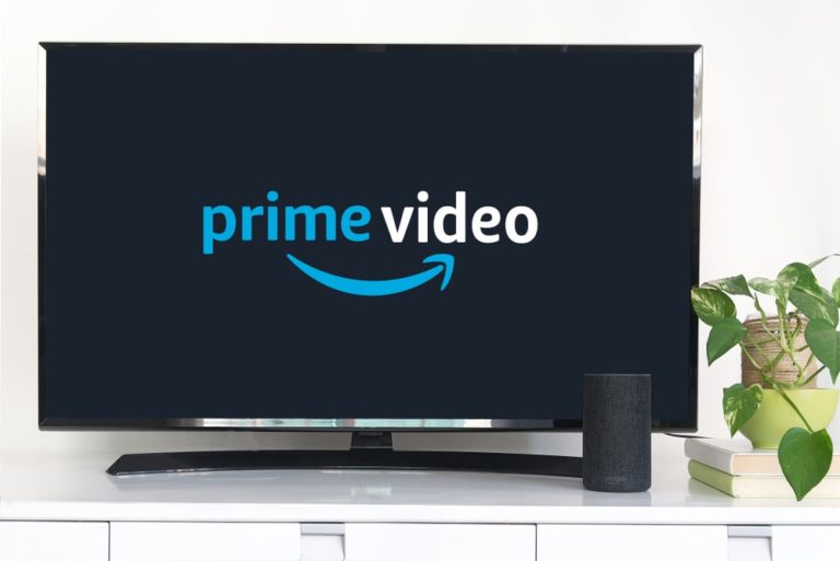 A living room TV showing the Amazon Prime logo.