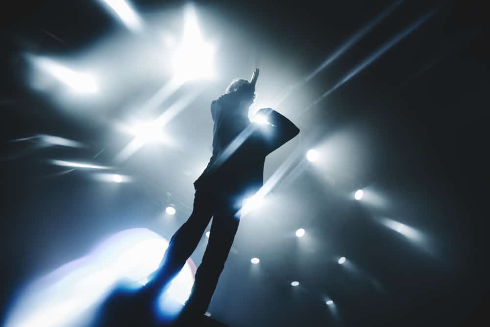 Singer performing on stage.
