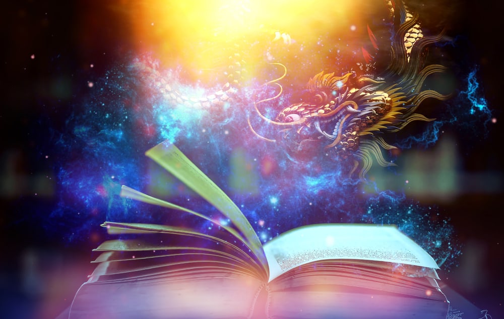A close look at a book opening with stars and a dragon above it.