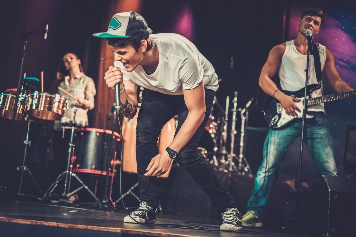 A man singing as the main vocalist of the band.