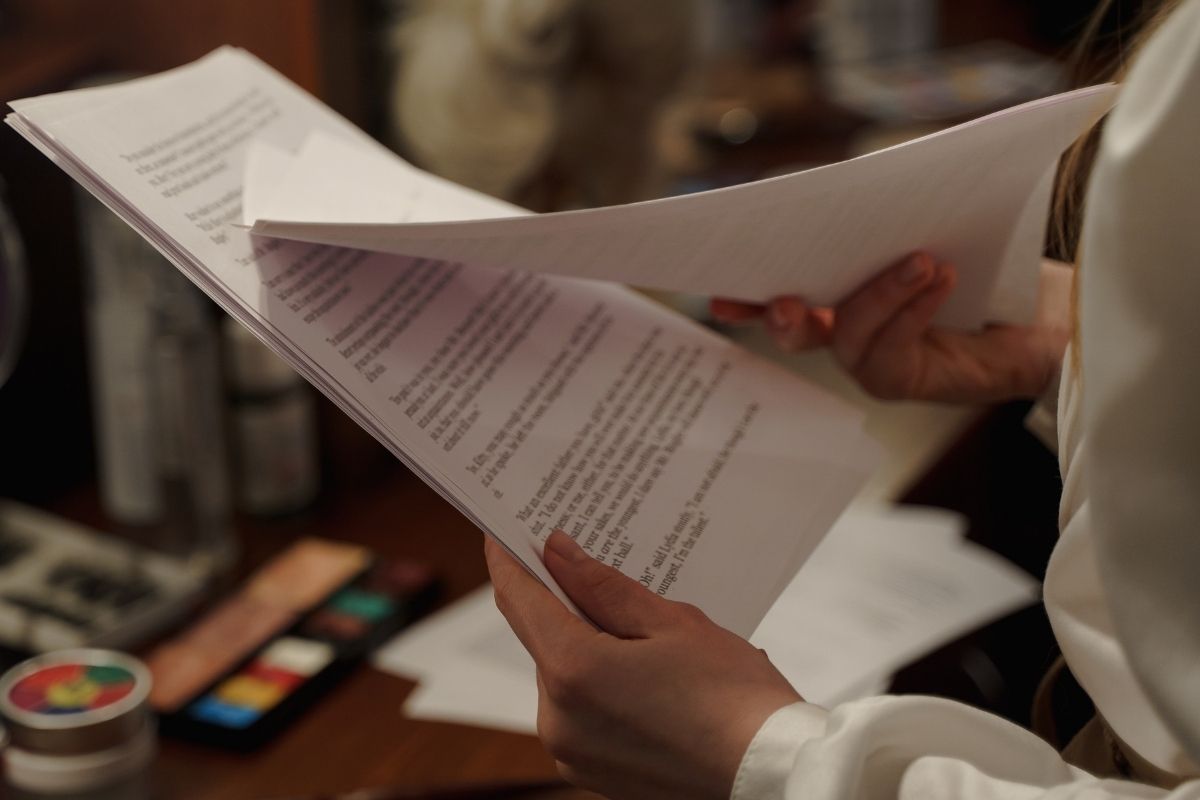 A photo of a person reading a script.