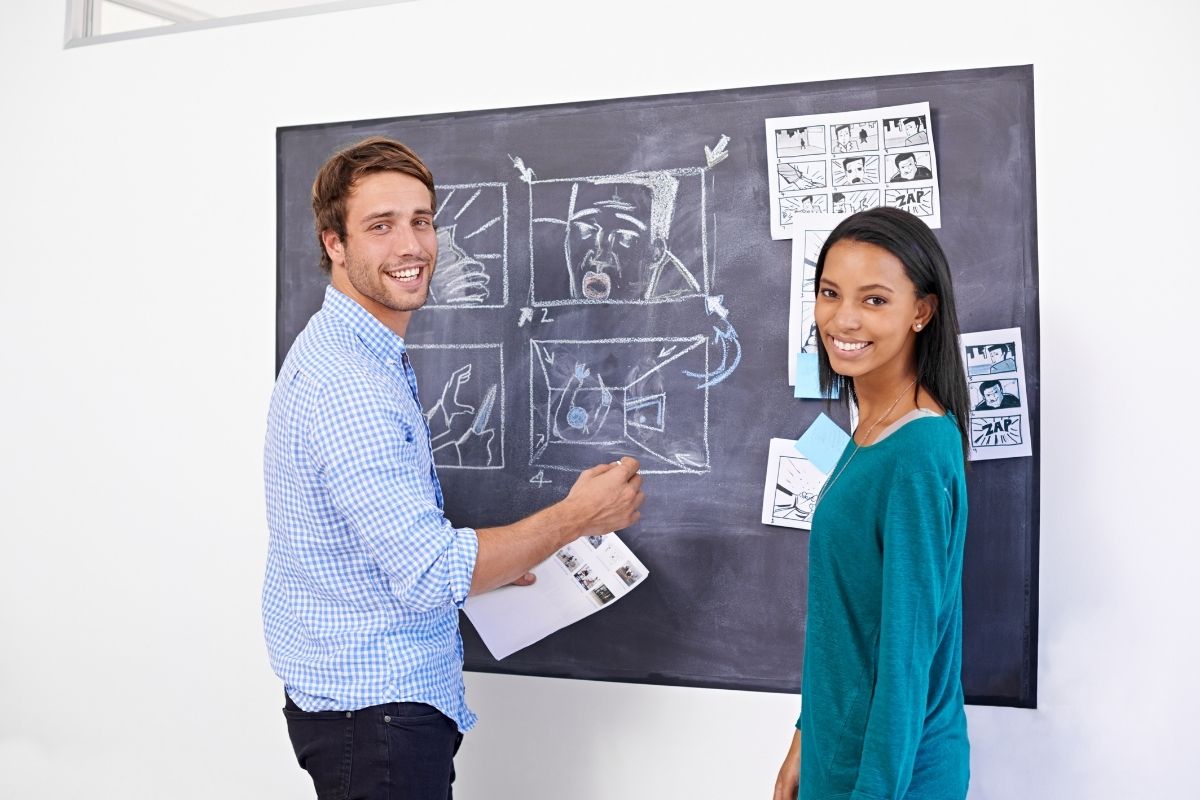 A photo of two people working on the storyboard.