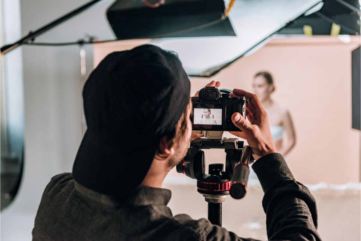 A camera man and his camera shooting.