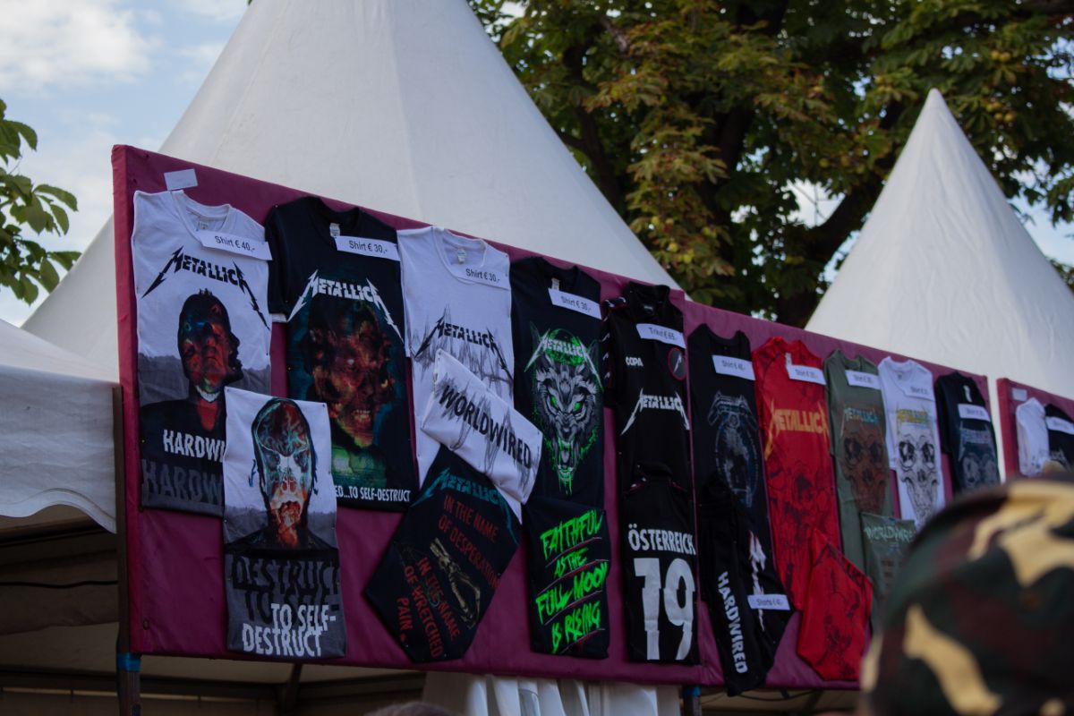 A photo of tshirt merchandise of concert.