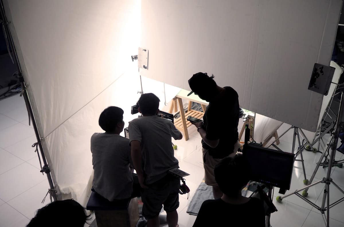 Film crew team shooting in home studio.