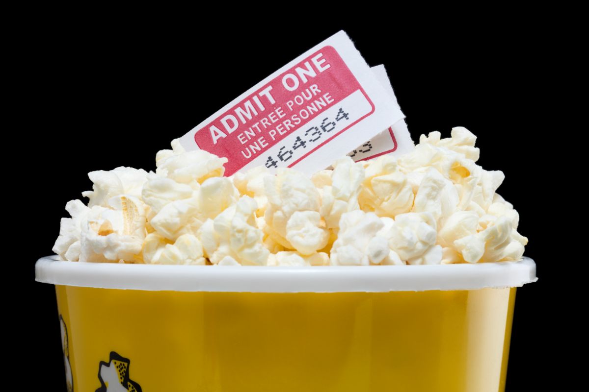 A bucket of popcorn and two cinema tickets.