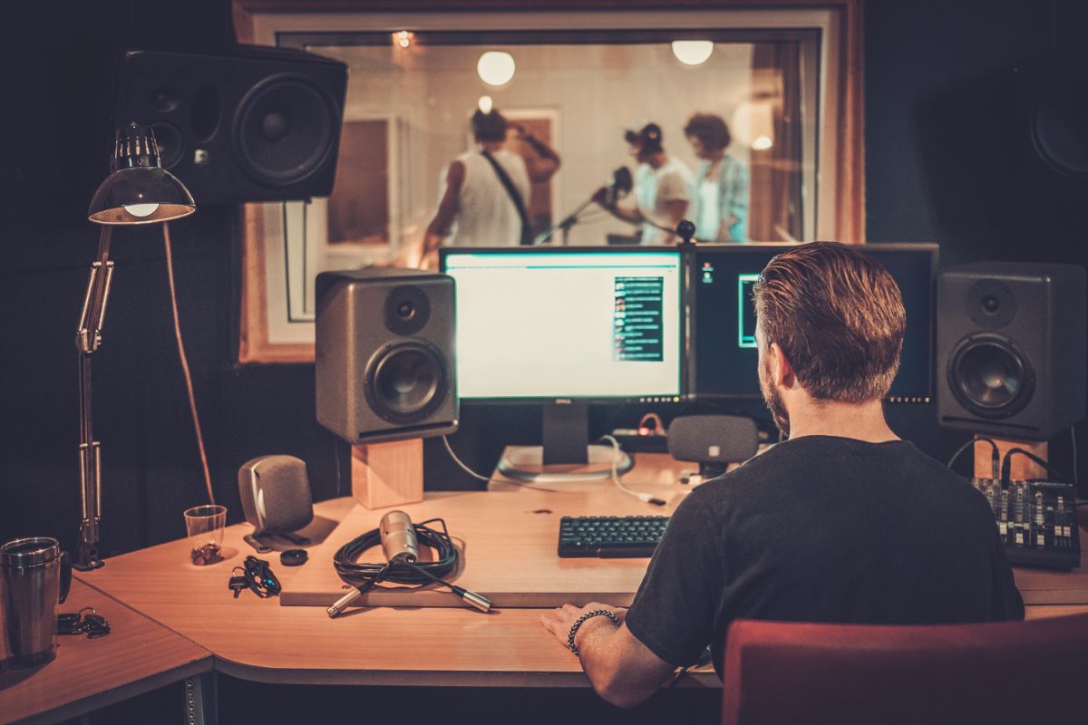 A music band at a music studio recording a song.