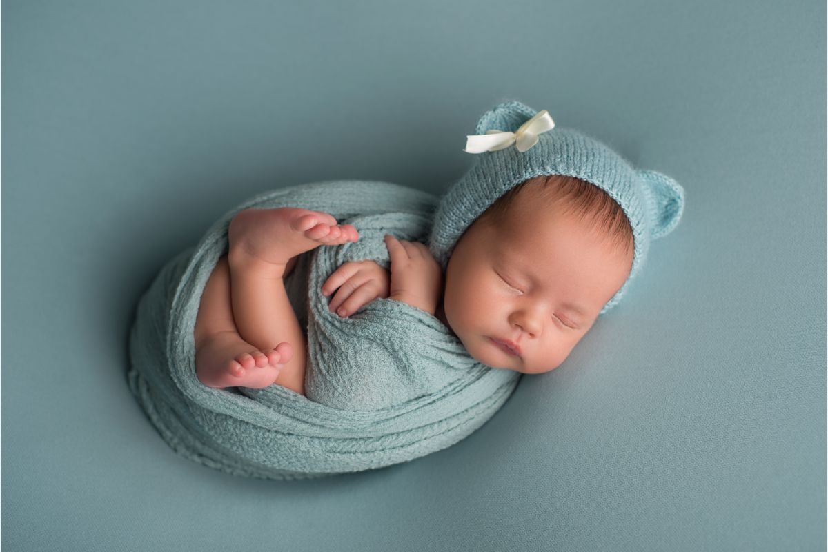 A sleeping newborn baby wrapped.