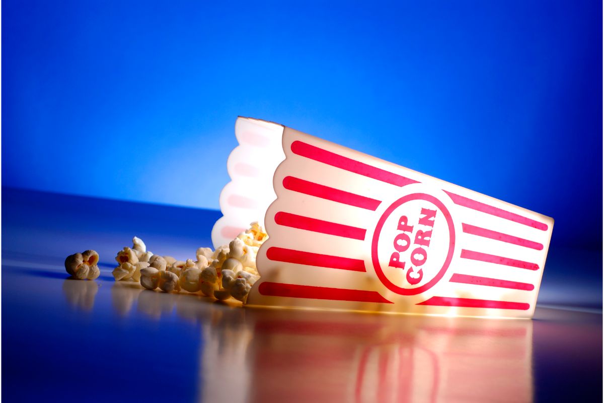 A photo of popcorn at the movies blue background.