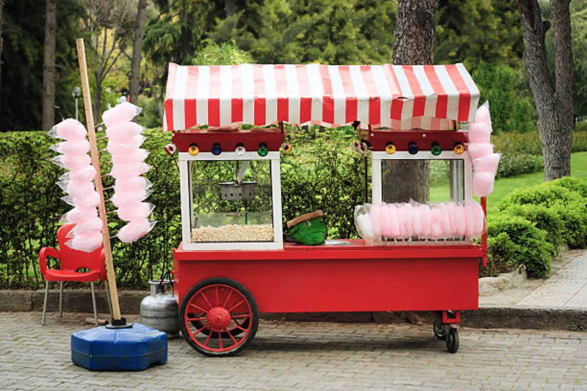 A vintage popcorn cart at the side of the street.