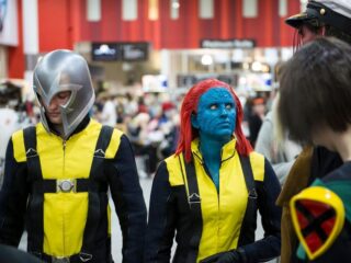 A photo of a guy and lady wearing costumes of the movie x men.