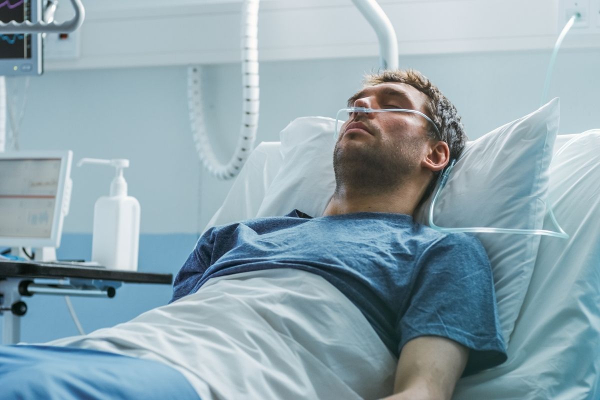 A hospital sick male patient sleeps on the bed.