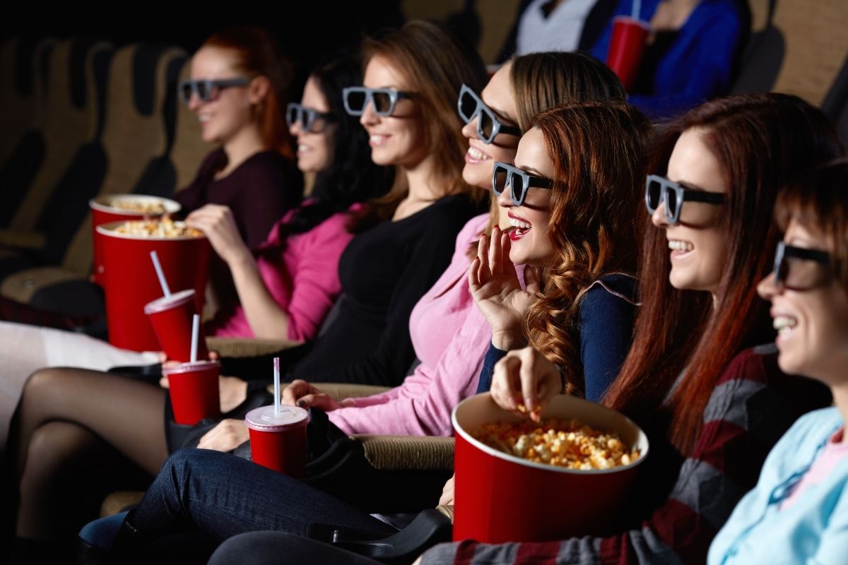 A group of friends laughing watching the comedy movie.