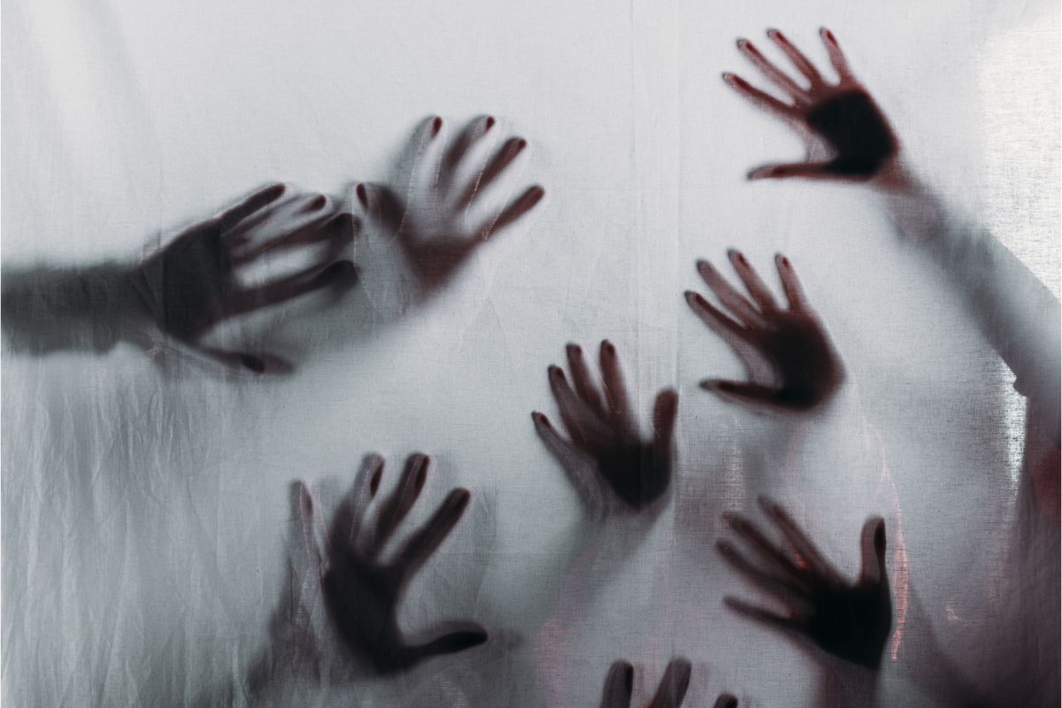 A horror movie scene a lot of hands.